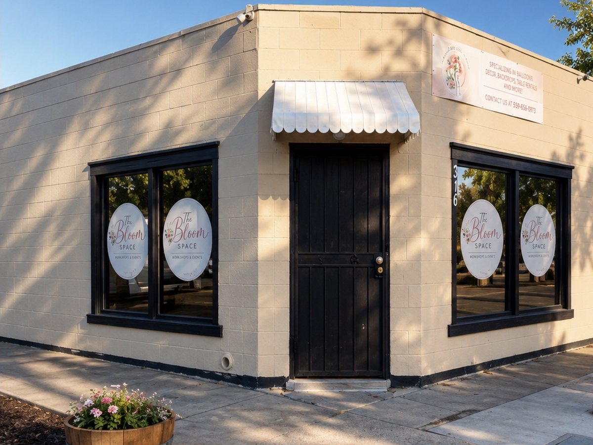 The Bloom Space on the corner of Bridge Street — cream block walls, a striped awning over a black door, and the logo on the windows